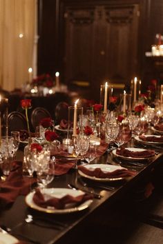 a long table is set with candles and plates