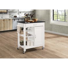 a white kitchen island with black top on wheels