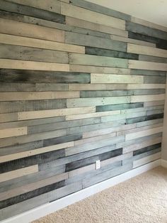 a wall made out of wooden planks in a room with carpet and white walls