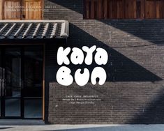 a black brick building with white lettering that says, kate bua on the side