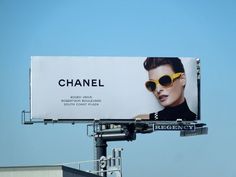 a billboard with a woman wearing sunglasses on it