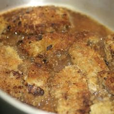 a pan filled with food sitting on top of a stove