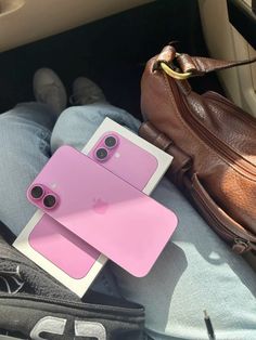 a cell phone case sitting on top of someone's lap next to a purse