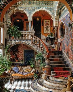 an elaborately decorated staircase leads up to the second floor in this ornate home with tiled floors and walls