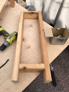 a table with some tools on top of it next to a piece of plywood