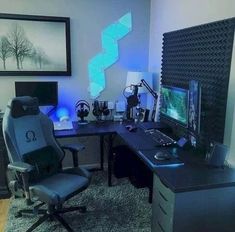 a computer desk with a monitor, keyboard and mouse on it next to a chair