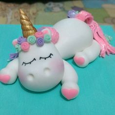 a cake shaped like a unicorn laying on top of a table