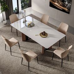 a dining room table with chairs around it and a painting on the wall behind it