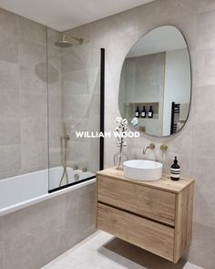 a bathroom with a sink, mirror and bathtub next to a walk in shower