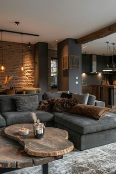 a living room filled with furniture and a brick wall behind the couch is a coffee table