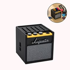 an electric guitar amplifier sitting on top of a wooden table next to a white background