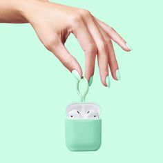 a woman's hand reaching for an airpods case