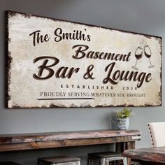 a wooden sign that says the smith's basement bar and lounge on top of a table