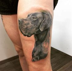 a woman's leg with a dog tattoo on it