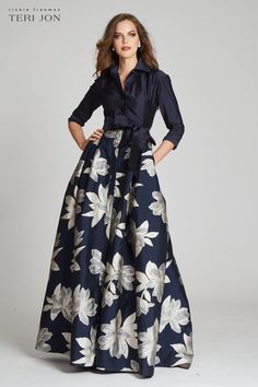 This variation of our classic shirt waist gown stuns on all! Featuring long cuffed sleeves, hidden front closure buttons, and a removable sash belt. The navy top paired with the multi-colored large floral print skirt is timeless and perfect for any season. Pair with navy or silver shoes to complete the look. Floor leng Jacquard Gown, Formal Wedding Guests, Large Floral Print, Makijaż Smokey Eye, Mob Dresses, 2024 Wedding, Maxi Shirt Dress, Floral Print Skirt, Mother Of The Bride Dress