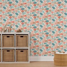 the wallpaper in this room is decorated with coral and blue flowers, which are accented with wicker baskets