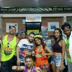 a group of young people standing next to each other in front of a sign that says island info