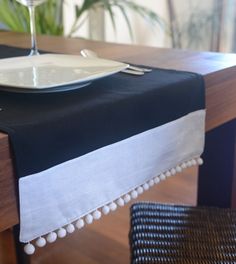 a table with a black and white table runner