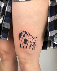 a cow and calf tattoo on the thigh