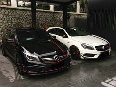 two black and white cars parked next to each other