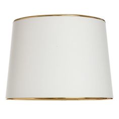 a white lampshade with gold trim on the bottom and side, against a white background