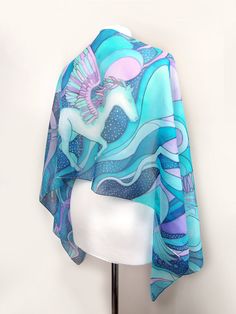 Hand painted scarf with Pegasus made of natural silk, in purple - blue - turquoise color set. This fantasy designer scarf is made to order. The Pegasus is a magical creature, a winged horse symbolizing wisdom and fame and more recently poets' inspiration (so imagine what a lovely gift the scarf would made for your poet friend). The Pegasus scarf depicts the winged horse flying with two peacocks on a starry, cloudy night sky. It is composed with tones of cool blue and turquoise, soft pastel mint Blue Hand Painted Bohemian Silk Scarf, Bohemian Blue Silk Scarf Gift, Bohemian Blue Silk Scarf As Gift, Blue Bohemian Hand Painted Silk Scarf, Bohemian Blue Silk Scarf For Gift, Bohemian Blue Hand Painted Silk Scarf, Artistic Handmade Blue Silk Scarf, Blue Shawl Scarf For Gift, Artsy Blue Scarf As A Gift