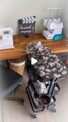 an ironing board sitting on top of a wooden table next to a sewing machine