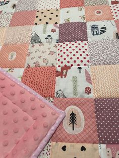 a close up of a patchwork quilt on a bed