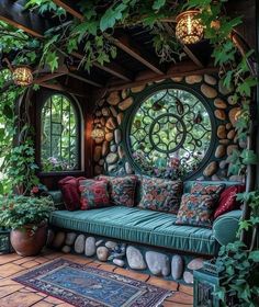 a green couch sitting under a circular window