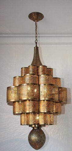 a chandelier hanging from the ceiling in a room with white walls and flooring