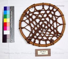 a woven piece of wood is shown next to a ruler and color swatches on a white tablecloth