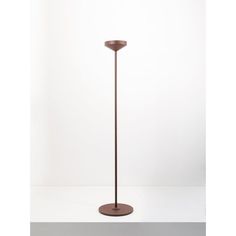 the floor lamp is brown and has a round base