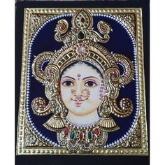 an intricately painted wall hanging with a woman's face in gold and blue