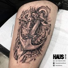 an anchor and compass tattoo on the right thigh, with other symbols surrounding it in black ink