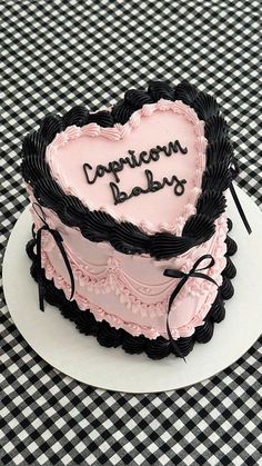 a heart - shaped cake with the words congratulations baby written on it sitting on a table