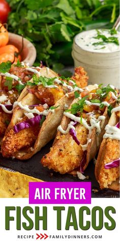 air fryer fish tacos on a tray with tomatoes and lettuce in the background