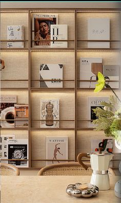 there is a vase with flowers in it on the table next to bookshelves