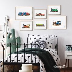 a child's bedroom with train prints on the wall above the bed and toys