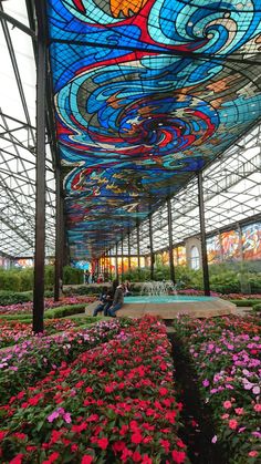 the inside of a building with many flowers in it