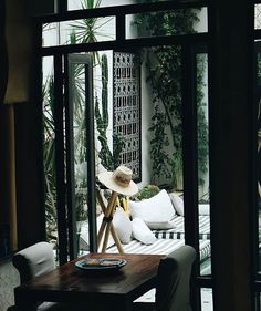 a living room filled with furniture and plants