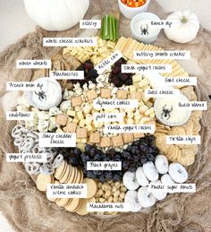 a cheese and cracker board is shown with all the different types of snacks on it