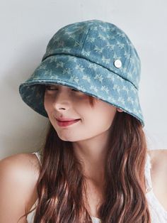 a woman wearing a blue hat with flowers on it