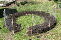 the garden is ready to be planted and put into the ground with sticks in it