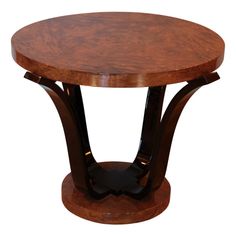 a round wooden table with two curved legs