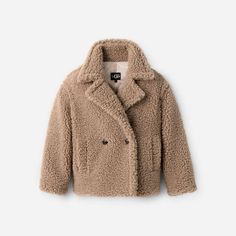 The evolution of our classic Gertrude, this double-breasted, high-texture coat is made from cozy (it'll keep you warm) material and it is designed to hit perfectly so you can catch all of your angles this season. | Hip-length double breasted teddy coat. Shell - 100% Polyester. Lining - 100% Polyester. The UGG® Logo faux horn buttons. Soft fleece  inchhand warmer inch pocket lining. 27 inch HPS Length [Size S]. 30 inch HPS Length [Size 2X]. Dry clean only. Imported. | UGG® Women's Gertrude Short Teddy Coat Faux Fur in Putty, Size XL Short Teddy Coat, Ugg Jacket, Textured Coat, Dutch Bros, Short Loungewear, Purse Coach, Teddy Coat, Classic Boots, Baby Boy Shoes