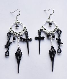 Long gothic charm earrings with stainless steel ear wires Black Punk Dangle Hoop Earrings, Black Dangle Hoop Earrings Punk Style, Black Dangle Hoop Earrings In Punk Style, Gothic Metal Hoop Earrings, Emo Pierced Jewelry For Halloween, Black Sterling Silver Fantasy Jewelry, Gothic Sterling Silver Adjustable Earrings, Black Fantasy Dangle Jewelry, Punk Style Surgical Steel Single Earring