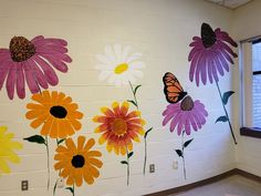 the wall is decorated with flowers and butterflies