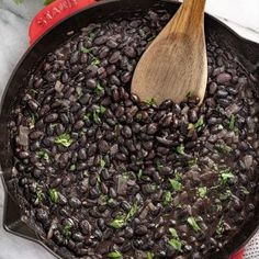 a skillet filled with black beans and parsley