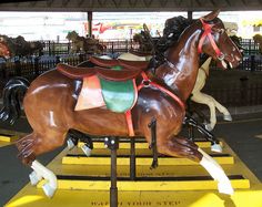 a carousel horse with saddles on it's back