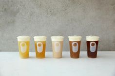 five different types of cups sitting on top of a white table next to each other